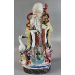 Chinese porcelain figure of 'Shou Lao' the God of longevity, the figure accompanied by a Crane. 34cm