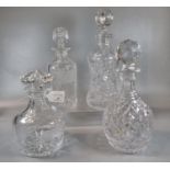 Group of four cut lead crystal decanters of different designs: hobnail cut, star cut, foliate