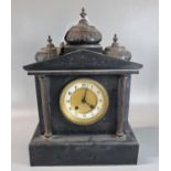 Early 20th century black slate two train architectural mantle clock, the case surmounted by minarets