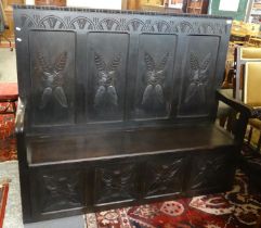 18th century style stained oak settle, the carved back with four fielded panels above a boxed hinged