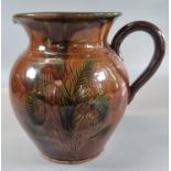 Brown glazed single handled baluster jug decorated with stylized leaves. (B.P. 21% + VAT)