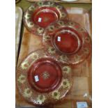 A set of three 19th Century cranberry glass gilt design dessert dishes, possibly Bohemian. (B.P. 21%