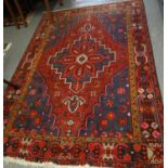 Shiraz red ground geometric and foliate carpet with central medallion. 195x128cm approx. (B.P. 21% +