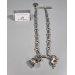 Silver gents pocket watch chain with T Bar and small collection of assorted charms to include: lions