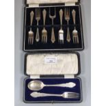 Cased christening spoon and fork set. 1.28 troy oz approx. together with a cased set of pickle