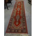 Pair or Persian design red ground floral and foliate runners with an arrangement on central