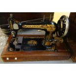 Singer hand sewing machine in wooden case of stepped design with turned carrying handles. (B.P.