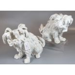 Pair of continental porcelain Blanc de Chine seated fireside dogs, blue mark to the underside. (