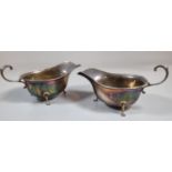 Two similar Georgian style silver sauce boats standing on three hoof feet, one by Atkin Brothers.