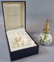 Modern Moorcroft enamel perfume bottle and stopper decorated with magnolia on an ivory ground.