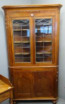 Victorian mahogany double corner cupboard with chequered banding under a moulded cornice, later lead