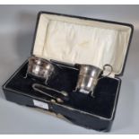 Early 20th century cased silver set comprising: helmet shaped cream jug, sucrier and matching