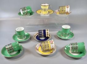 Set of nine English Porcelain Crescent coffee cans and saucers with silver mounted cup holders by
