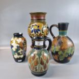 Collection of Gouda Dutch pottery items, all with multi-coloured floral and similar designs to