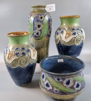 Collection of Royal Doulton stoneware items, raised with tube lined decoration of stylised flowers