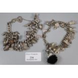 Two silver charm bracelets with a large collection of assorted charms; animals, chair, wishbone,