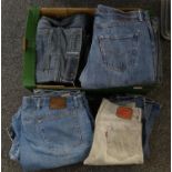 Box of vintage denim jeans, mostly Levi's, some Wrangler and others. In various sizes, some but