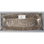 Silver pin tray of rectangular form decorated with relief scene of huntsman on horses with hounds.