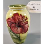 Moorcroft pottery tube lined vase of ovoid form decorated in the Hibiscus pattern. 11cm high approx.