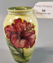 Moorcroft pottery tube lined vase of ovoid form decorated in the Hibiscus pattern. 11cm high approx.