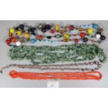 Collection of necklaces to include: greenstone guard style necklace, coral necklace and millefiori