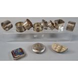 A collection of silver and plated napkin rings, together with tobacco/snuff box and another shell
