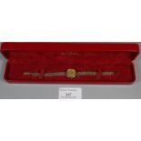 9ct gold Omega ladies wristwatch in original box, having circular face marked 'Swiss made'. 15.4g