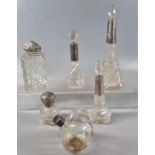 A collection of early 20th Century glass and silver topped dressing table bottles, perfume bottles
