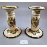 A pair of Royal Doulton 'Canterbury Pilgrims' candlesticks. (B.P. 21% + VAT)
