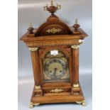 Early 20th Century oak architectural two train mantel clock with urn finial, gilded and gold