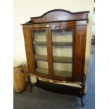 Edwardian mahogany inlaid bow front two door glazed display cabinet standing on cabriole legs and