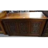18th century style carved oak coffer, the moulded top above three carved and fielded panels standing