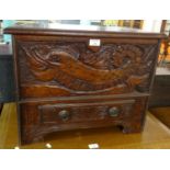 Unusual carved and stained coffwr bach, the moulded hinged top above a front panel with mythical