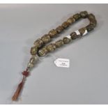 String of Tibetan carved green stone prayer beads carved as masks with pendant tassel. (B.P. 21% +