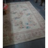 Cream ground Chinese wash rug decorated with dragons chasing a flaming pearl. 253x154cm approx. (B.