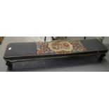 Victorian footstool of low proportions on stained wooden cabriole legs and scroll feet with floral