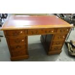 Early 20th century oak knee hole desk, the leather inset and moulded top above a bank of three