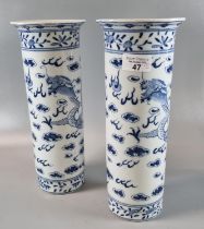 A pair of probably Chinese, transfer printed blue and white cylinder vases. 30cm high approx, with