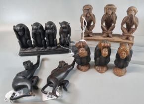 A mixed group of carved wooden monkey figures in various poses; three wise monkeys (see no evil,