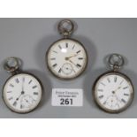 Three silver key wind open face lever pocket watches, all with Roman numerals and seconds dials. (3)
