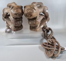 An African carved wooden ‘marriage’ or ‘wedding’ chain with wall brackets in the form of pairs of