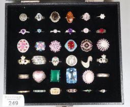 Thirty six hallmarked 925 - 958 silver dress rings contained in a glazed ring box. (B.P. 21% + VAT)