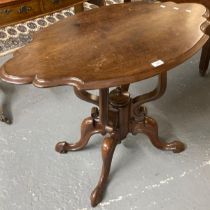 Victorian style mahogany table, the shaped oval top above a carved ornate quatrefoil base. (B.P. 21%