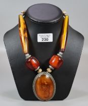 Large amber-coloured necklace with carved beadwork. (B.P. 21% + VAT)