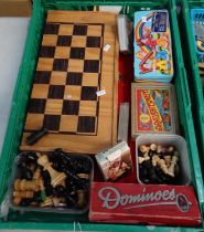 Box of games and game pieces to include: a chess board, chess pieces, checkers pieces, dominoes,