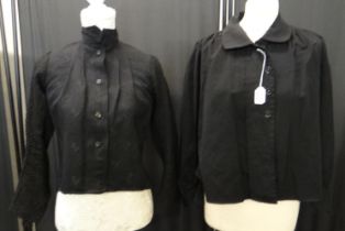 Two late 19th/early 20th Century black jackets; one damask with geometric patterns and textured