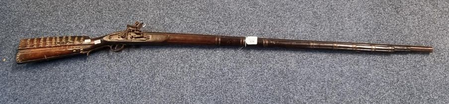 Probably Indian muzzle loading flintlock musket with replacement action and brass studded stock. (