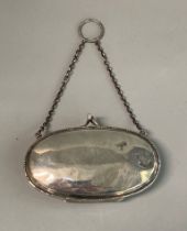 Edwardian design silver oval shaped ladies purse with chain and ring holder. Rubbed hallmarks. (B.P.