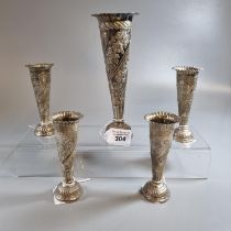 Set of four silver trumpet shaped spill/specimen vases with repoussé floral decoration together with