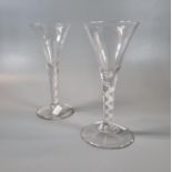 Two similar Georgian design air twist stem wine glasses/goblets with a trumpet bowl on a conical